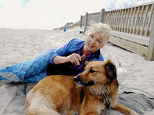 Photograph of the artist Susan Ray Euler and her dog Bella on a North Carolina beach.