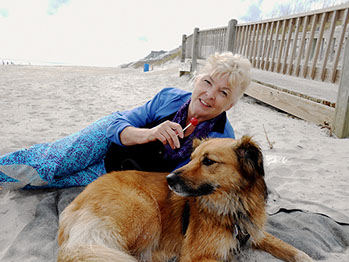 Photograph of the artist Susan Ray Euler and her dog Bella on a North Carolina beach.